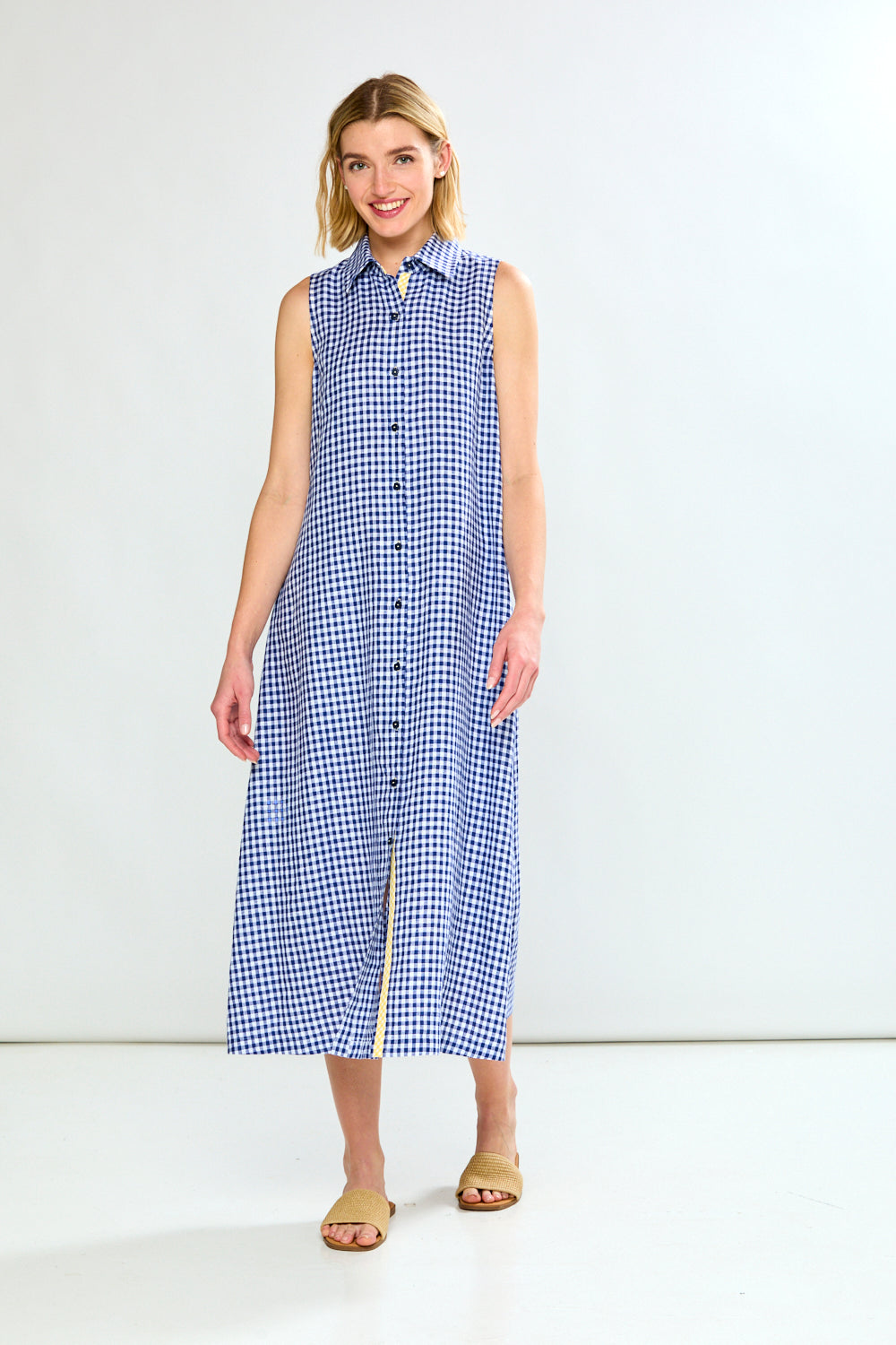 Woman wearing a blue checkered dress against a white background