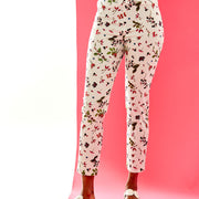 Woman in white pants with a berry print