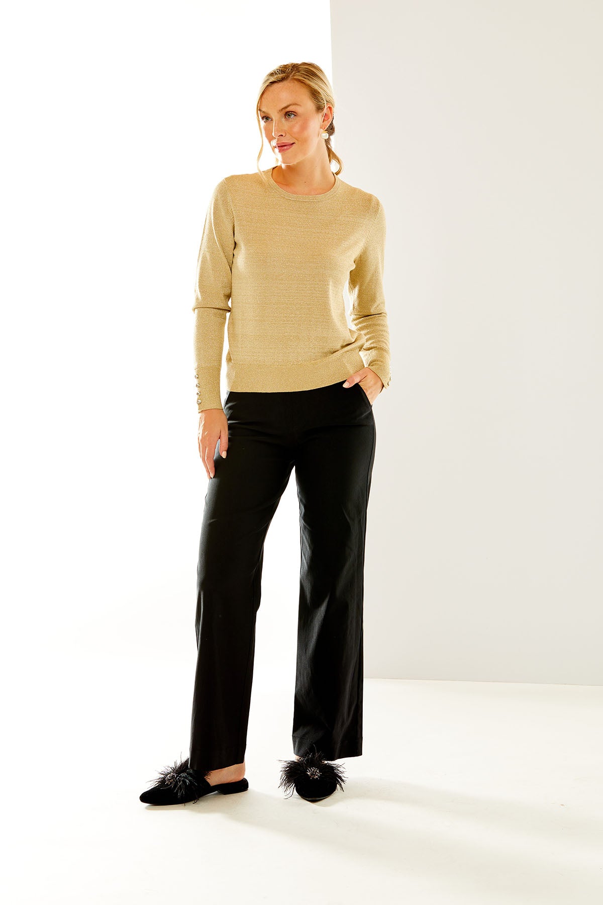 Woman in gold shimmer crewneck pullover