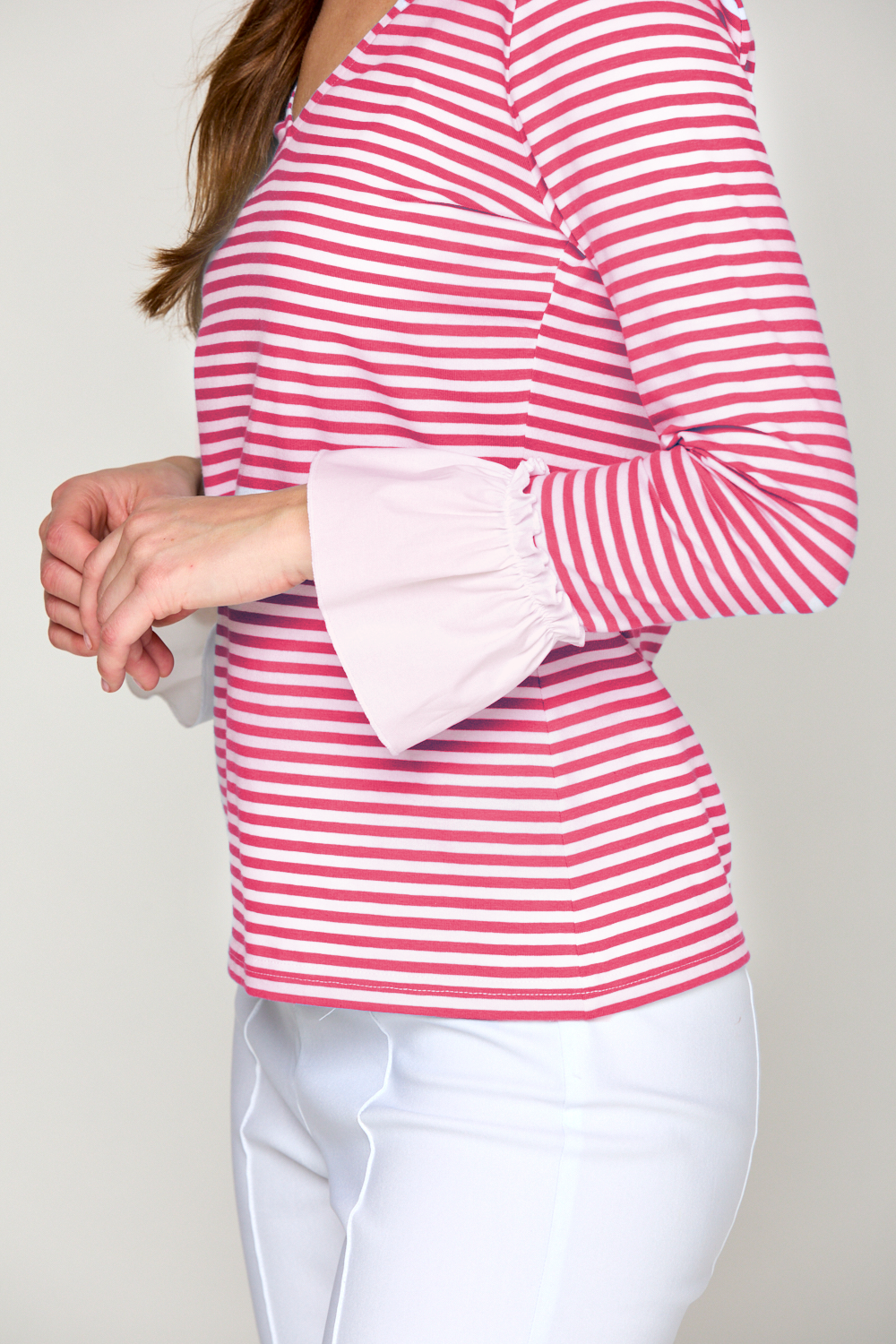 Woman in fuchsia and white stripe top