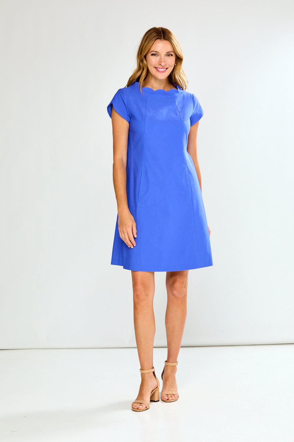 Woman wearing a blue dress against a white background