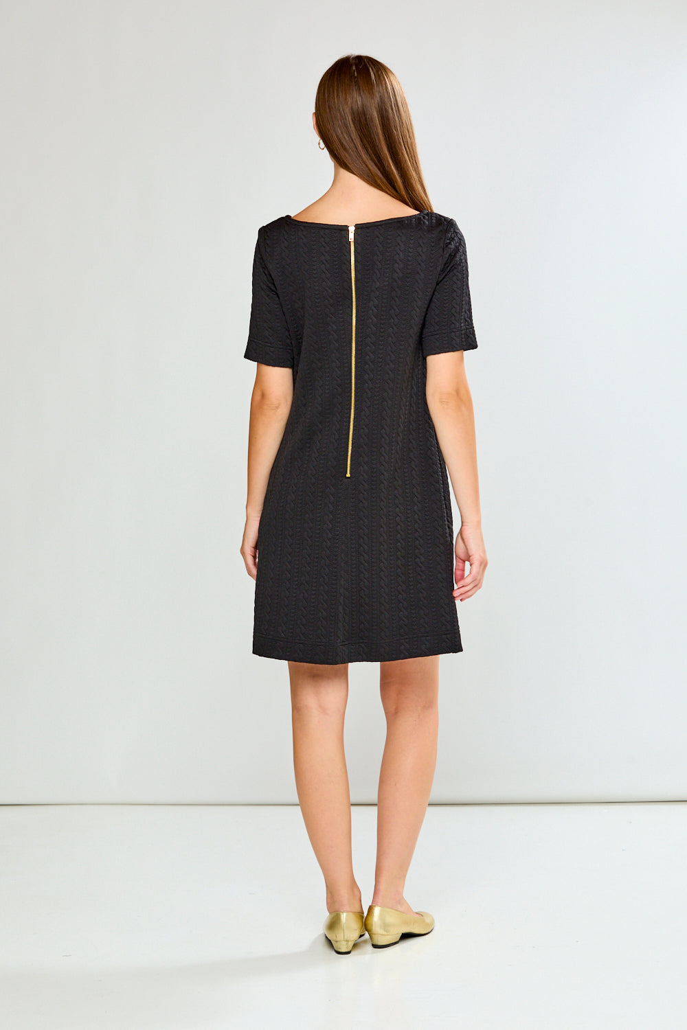 Woman wearing a black dress with a white background
