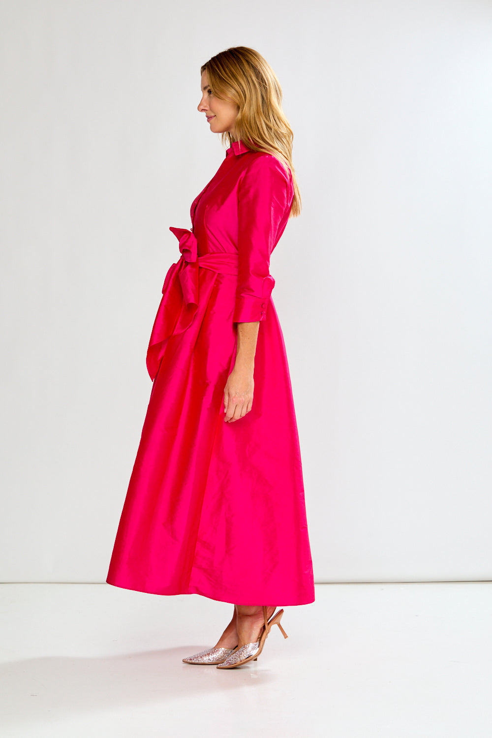 Woman wearing a Fuchsia dress on a white background