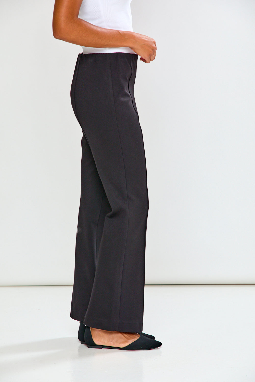 Person wearing black pants on a white background