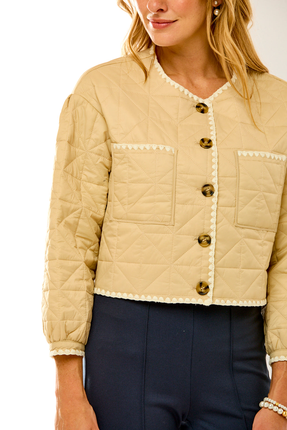 Woman in sand quilted jacket