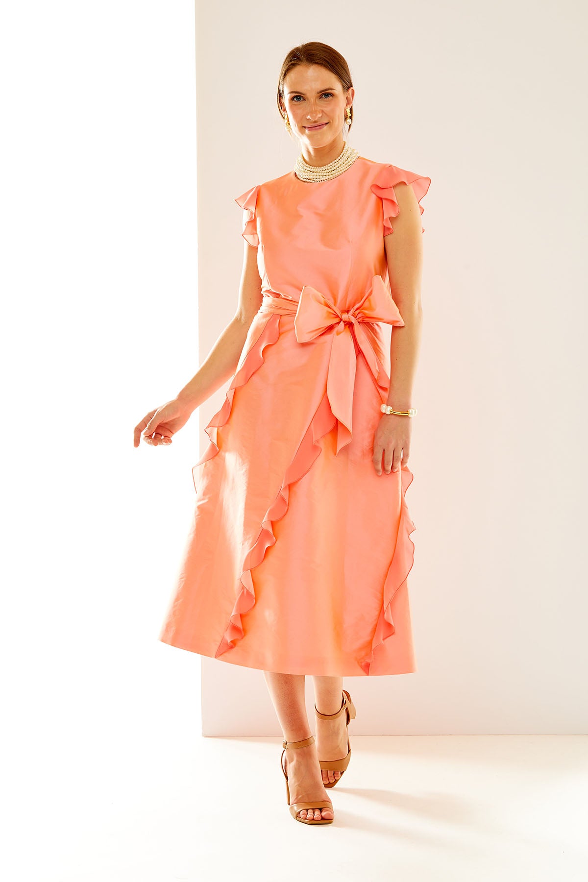 Woman in coral taffeta dress