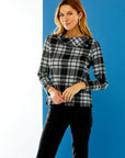 Woman in black/white plaid top