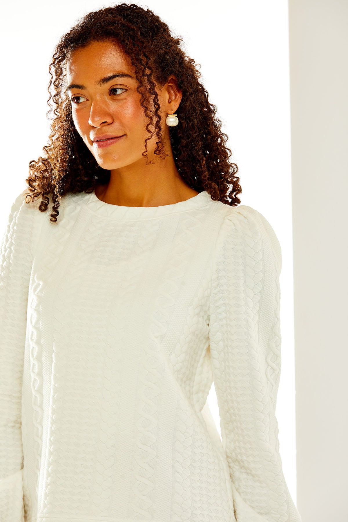 Woman in white cable knit top