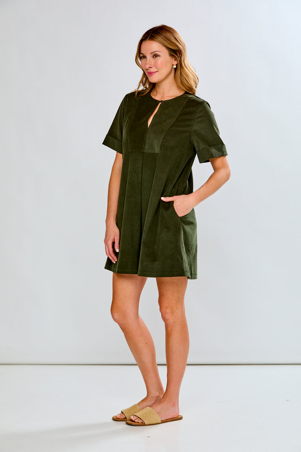 Woman wearing a green dress against a white background