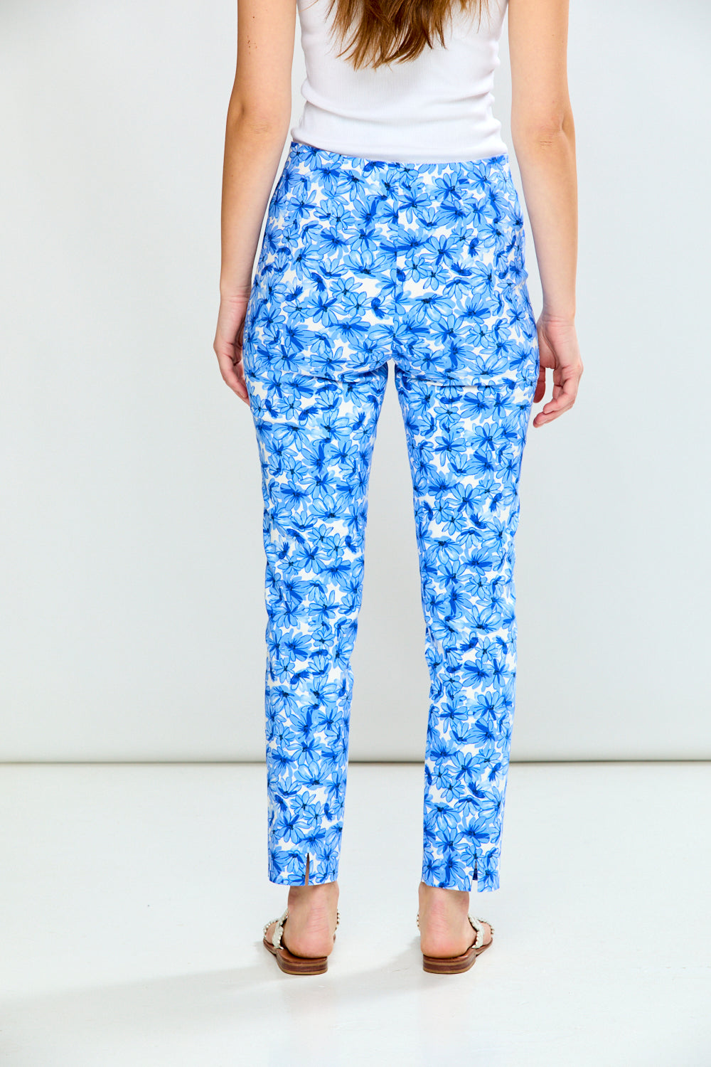 Person wearing blue floral pants on a white background