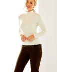 Woman in ivory long sleeve top