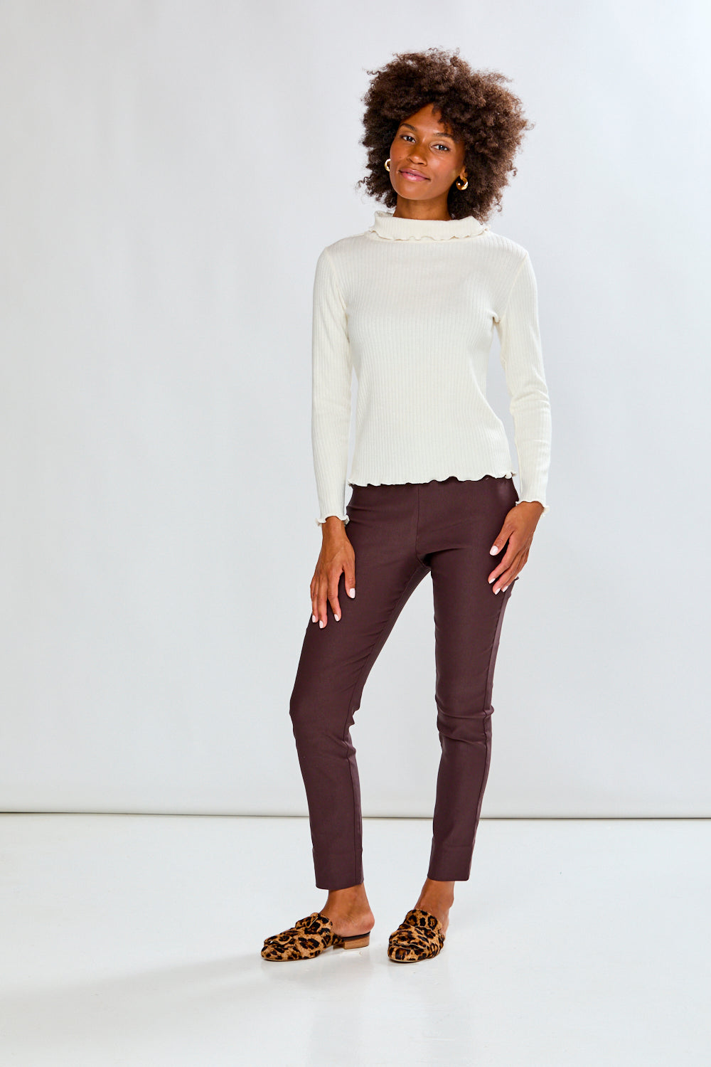 Woman in ivory top and dark pants