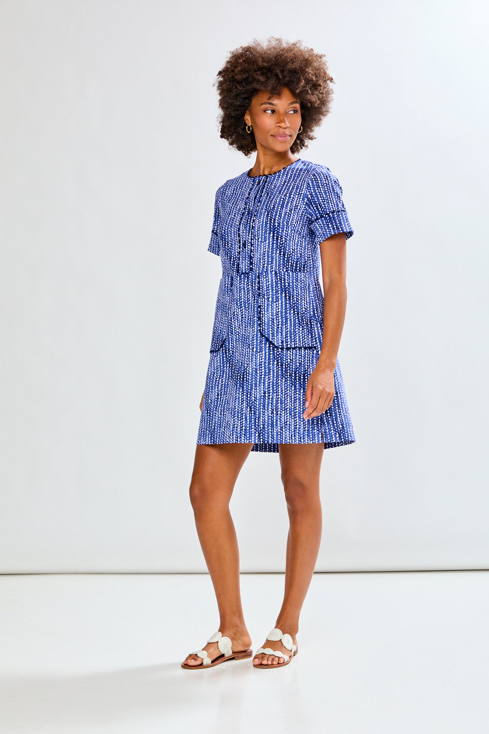 Woman wearing a blue dress with a white background