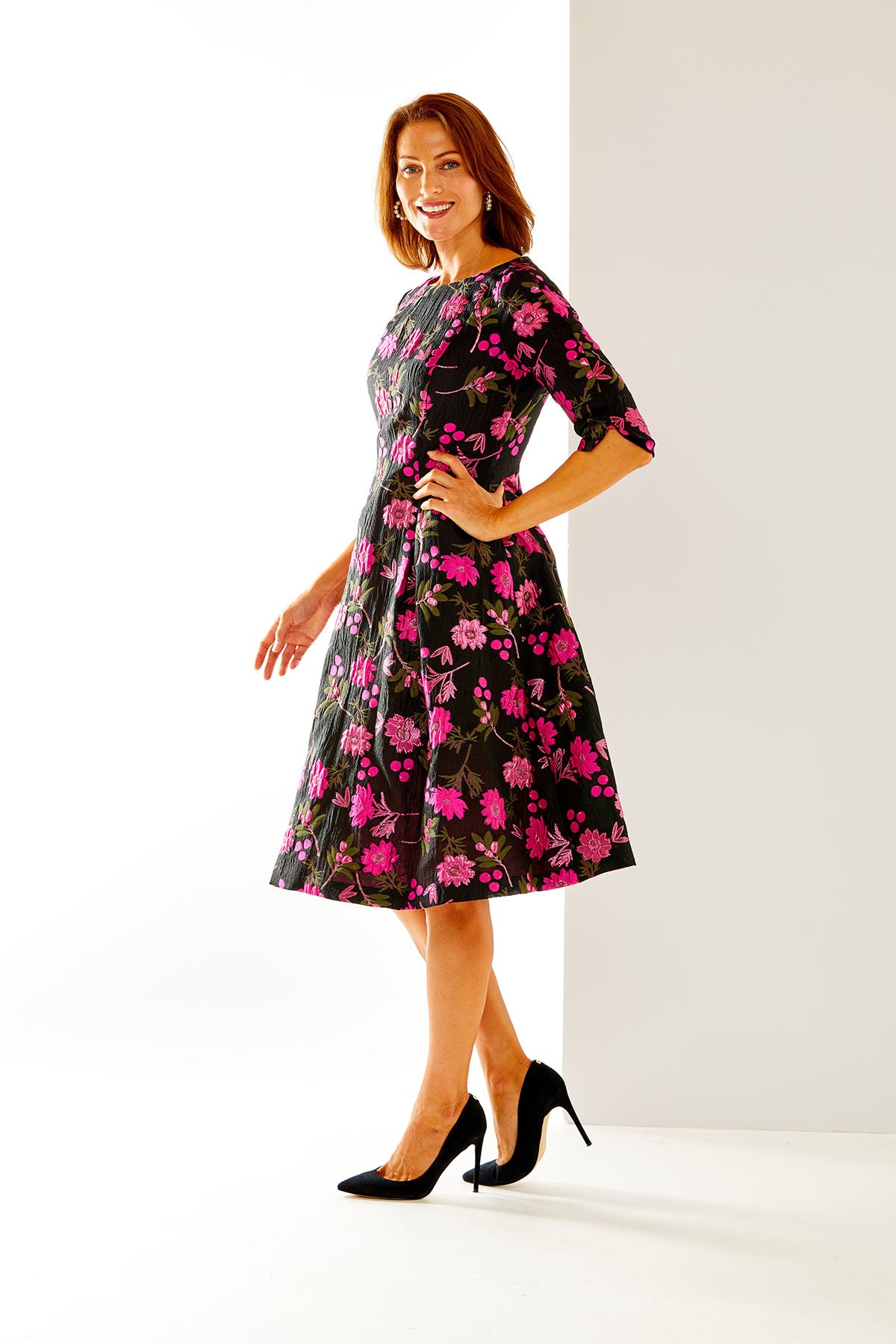 Woman in fit and flare floral dress