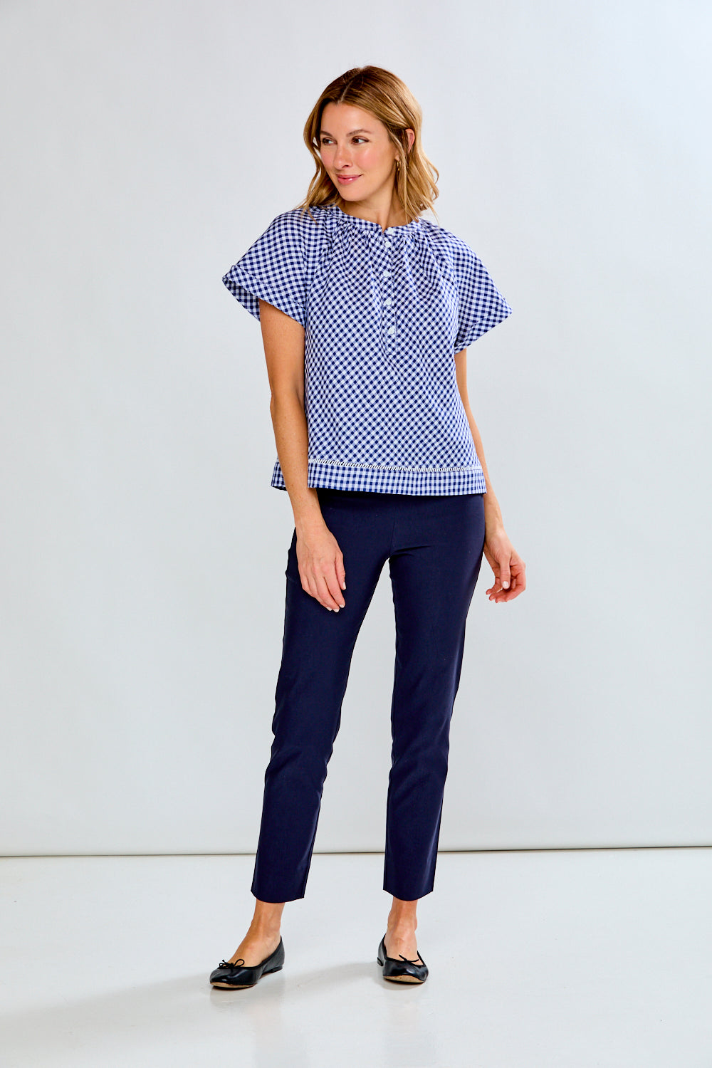 woman in navy gingham top