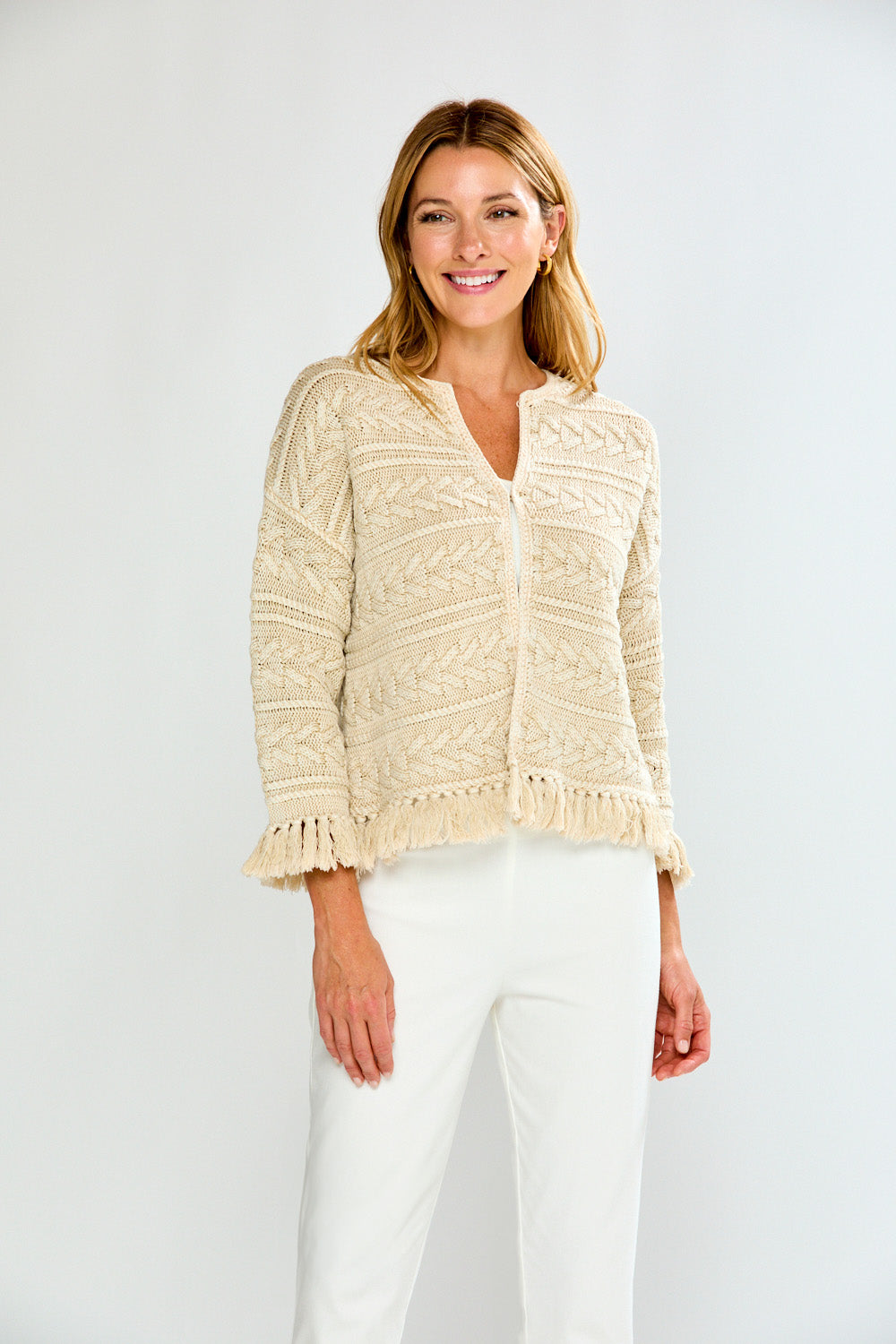 Woman in pebble cardigan with white pants
