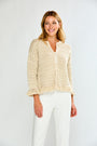 Woman in pebble cardigan with white pants