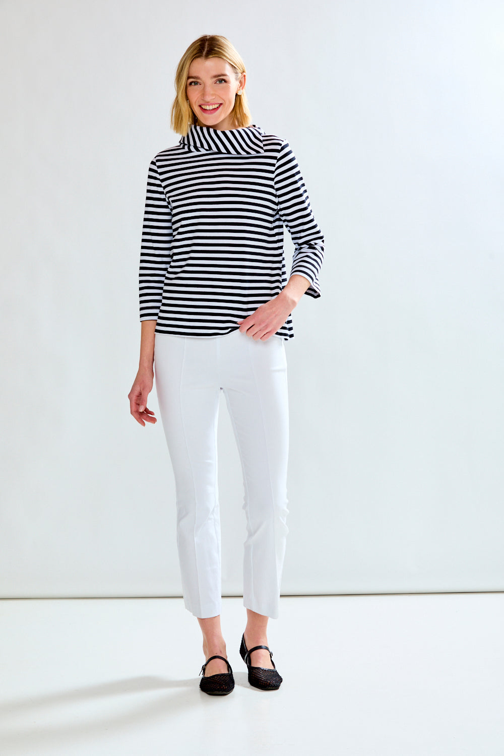 Woman in a white and black striped knit top