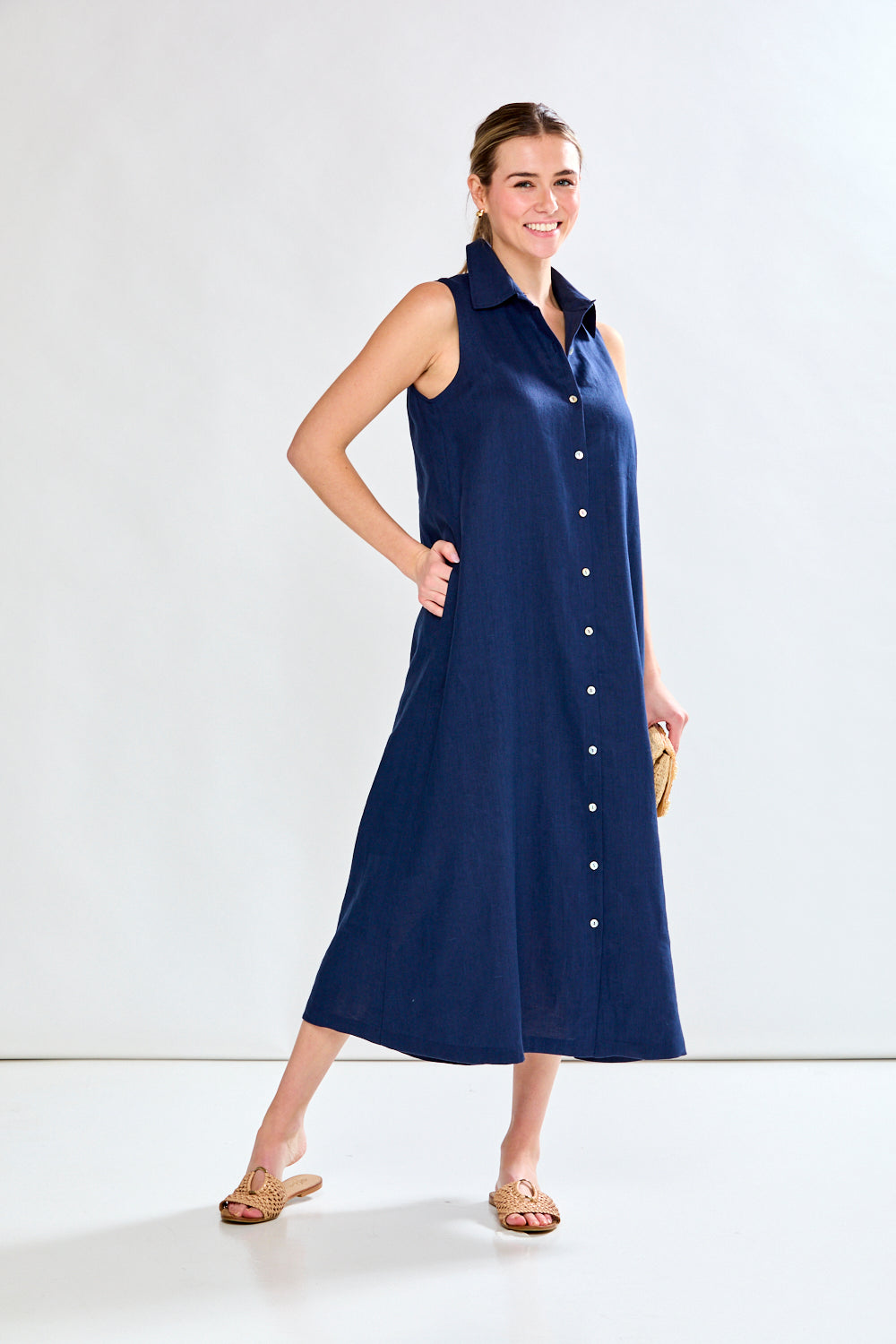 Woman in navy sleeveless dress
