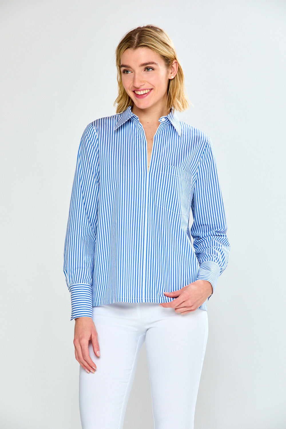 Woman wearing a blue and white striped shirt against a plain background