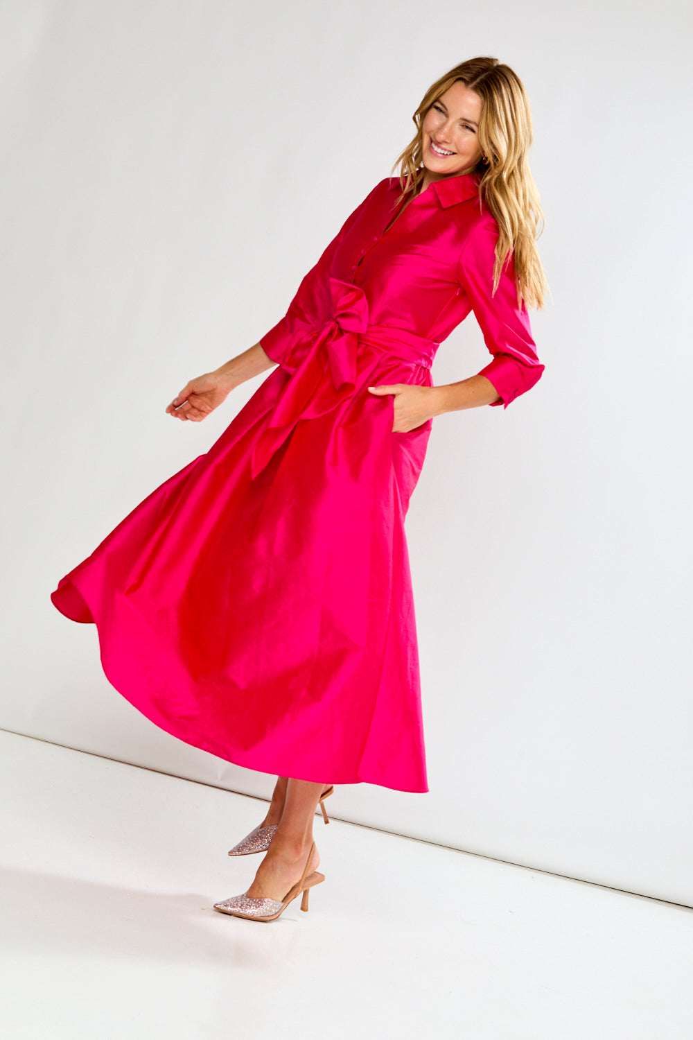 Woman wearing a Fuchsia dress on a white background