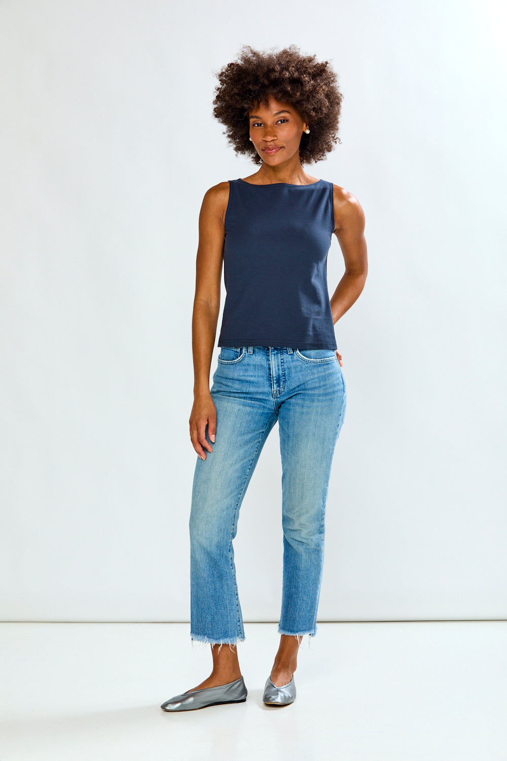 Woman in solid top and jeans