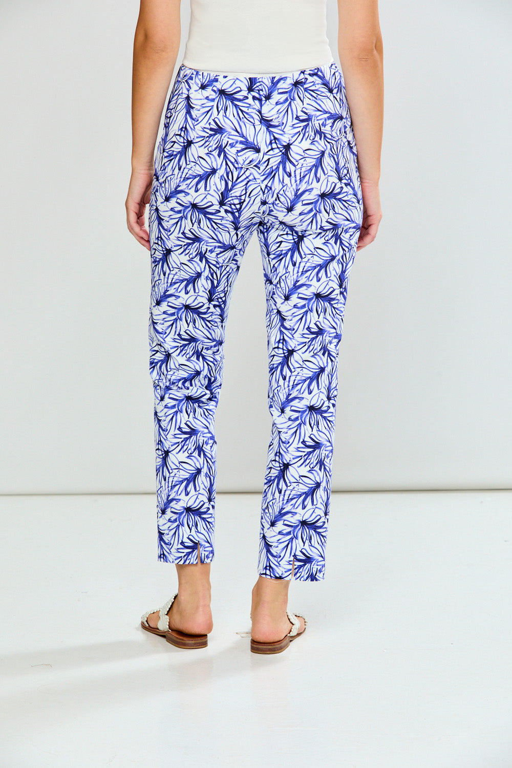 Person wearing blue floral pants on a white background
