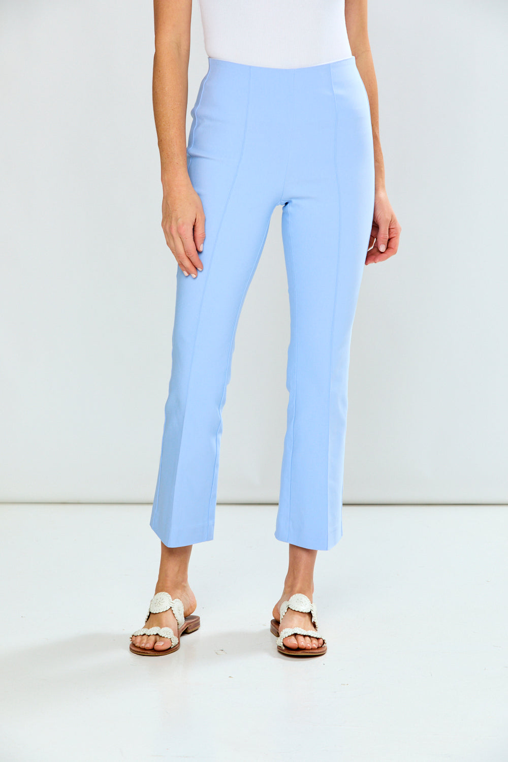 Light blue pants worn by a person on a white background