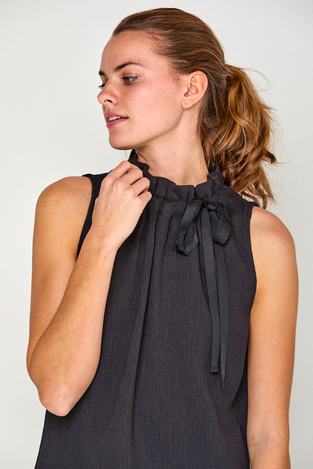 Woman in black sleeveless blouse