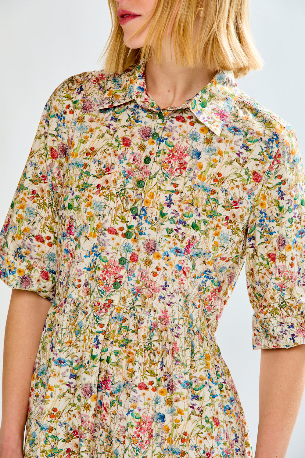 Woman wearing a floral dress with a white background