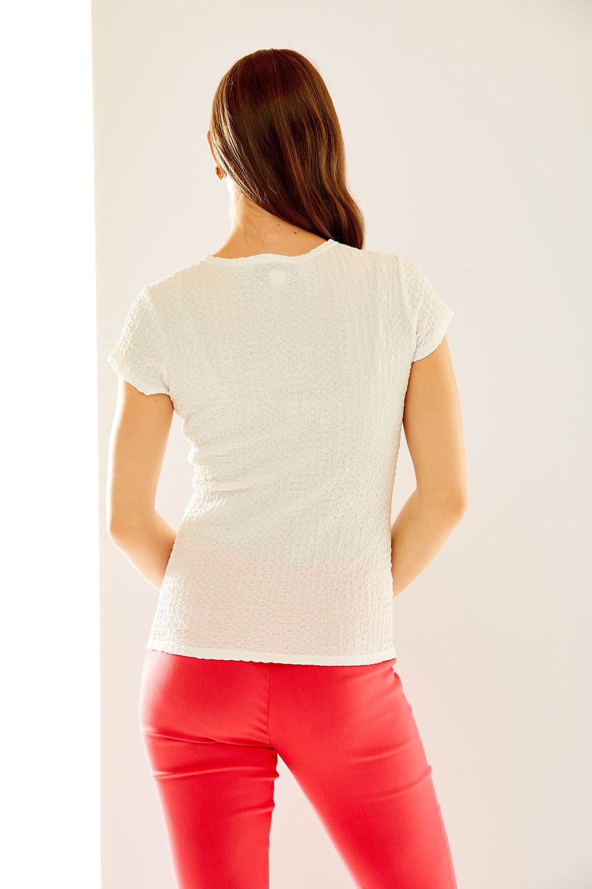 Woman in white textured knit tee
