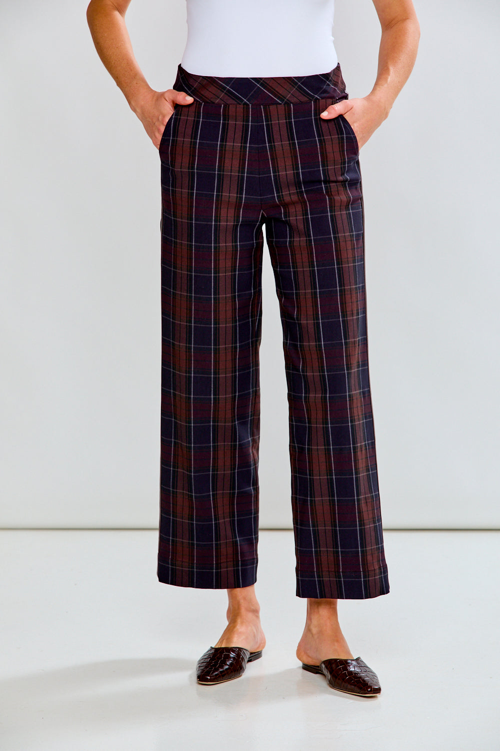 Person wearing plaid pants with a white background