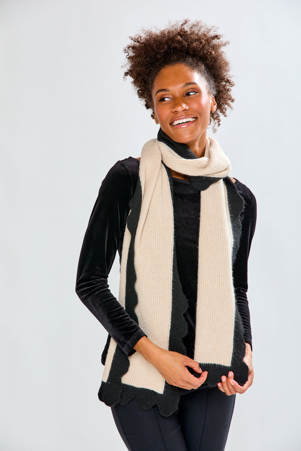 Woman wearing a beige scarf against a white background