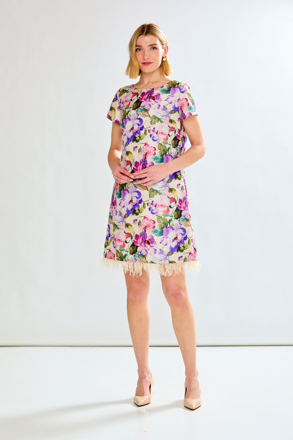 Woman in floral dress with feathers