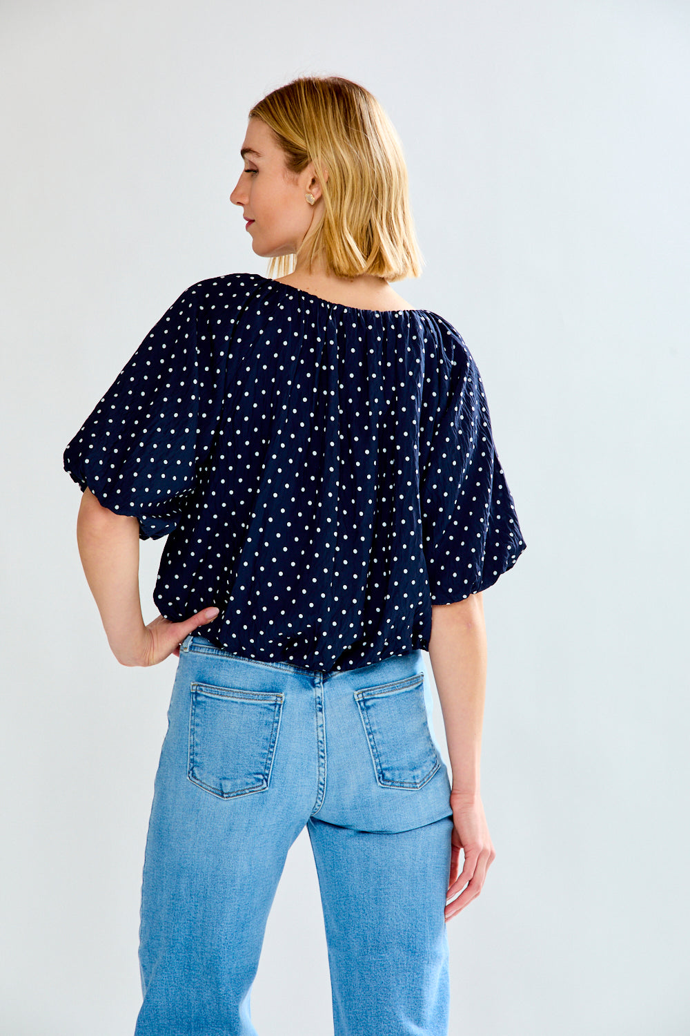 woman with polkadot shirt and jeans