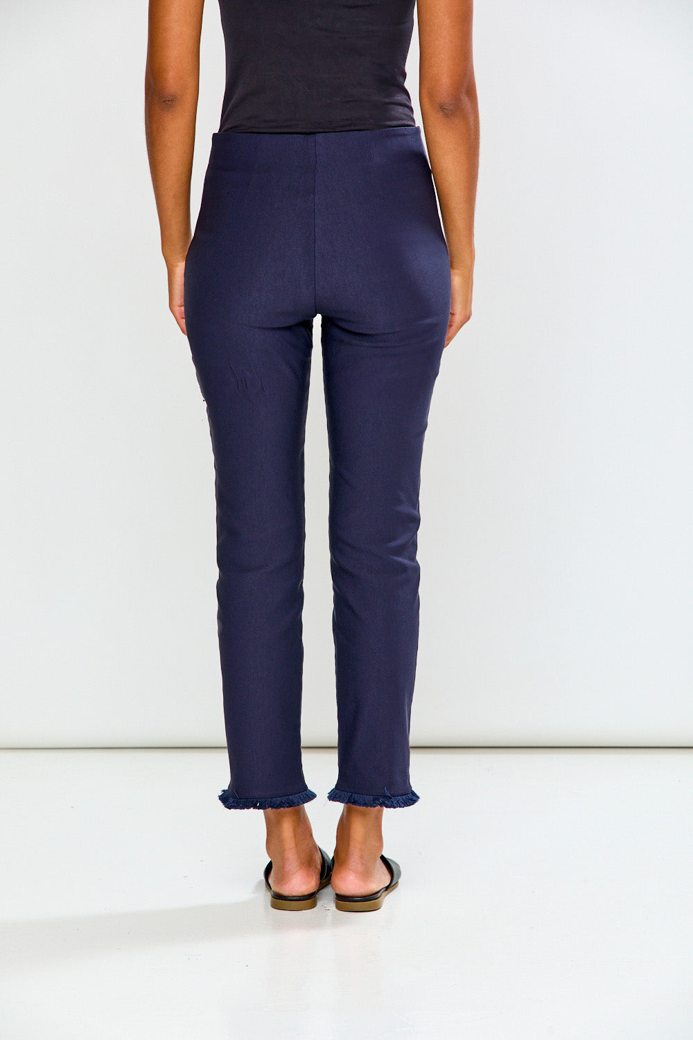 Woman wearing navy blue pants on a white background