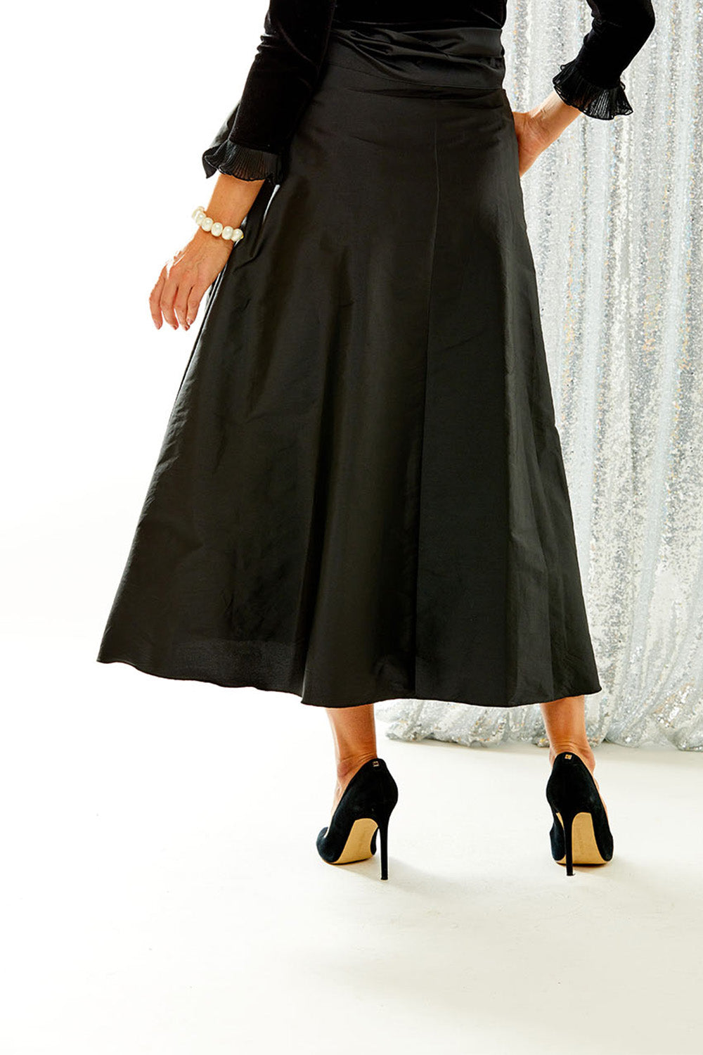Woman wearing black taffeta skirt