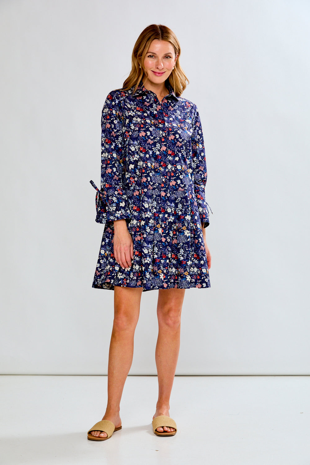 Woman wearing a floral dress against a white background