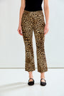 A model wearing leopard-print cropped flare pants with a black top and black flats, shown from the waist down against a plain white studio background.