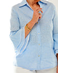 Woman in light blue button down blouse