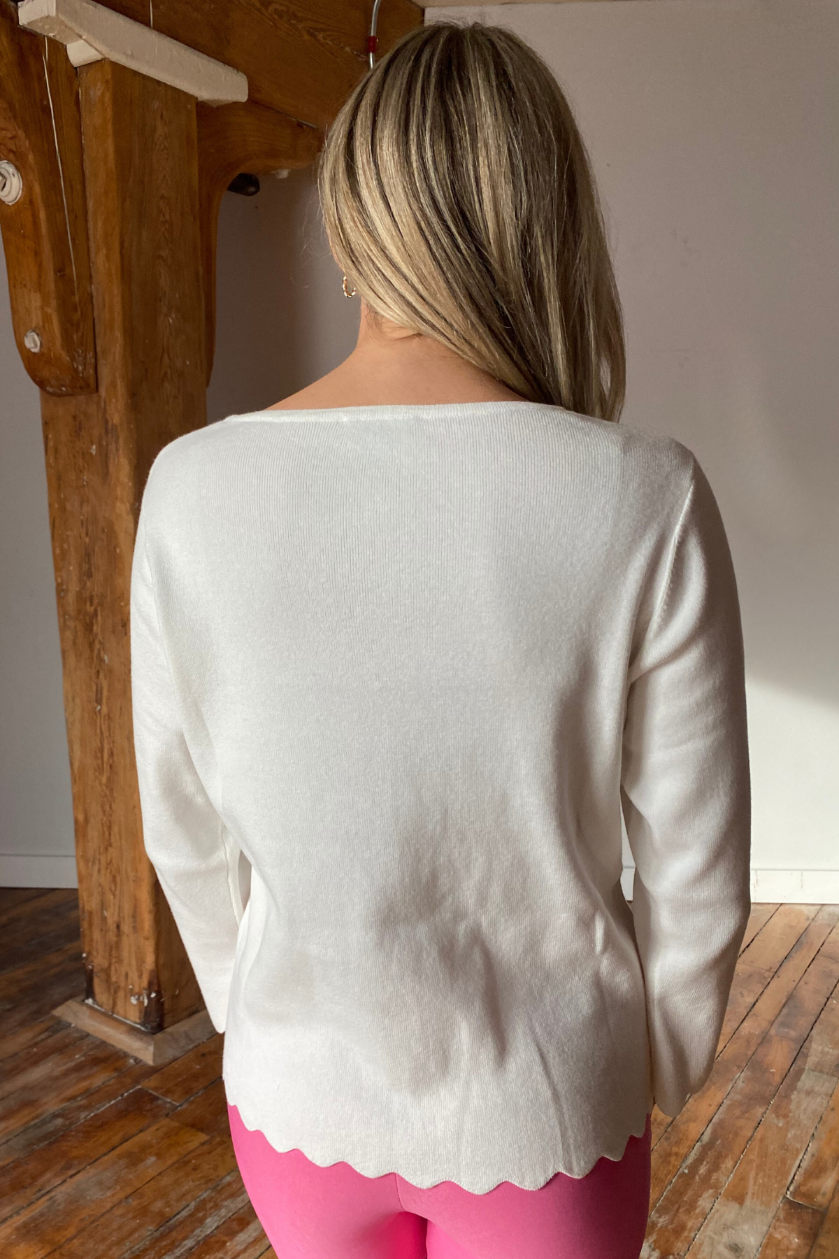 Woman in white scallop hem pullover