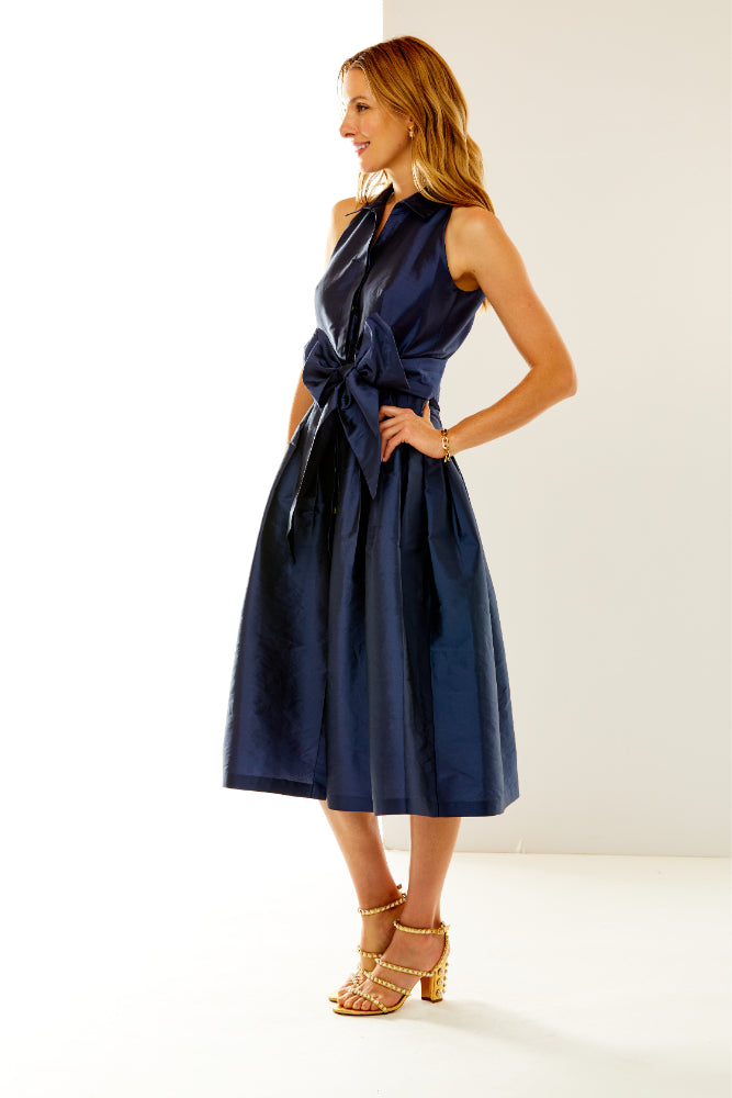 Woman in navy taffeta dress