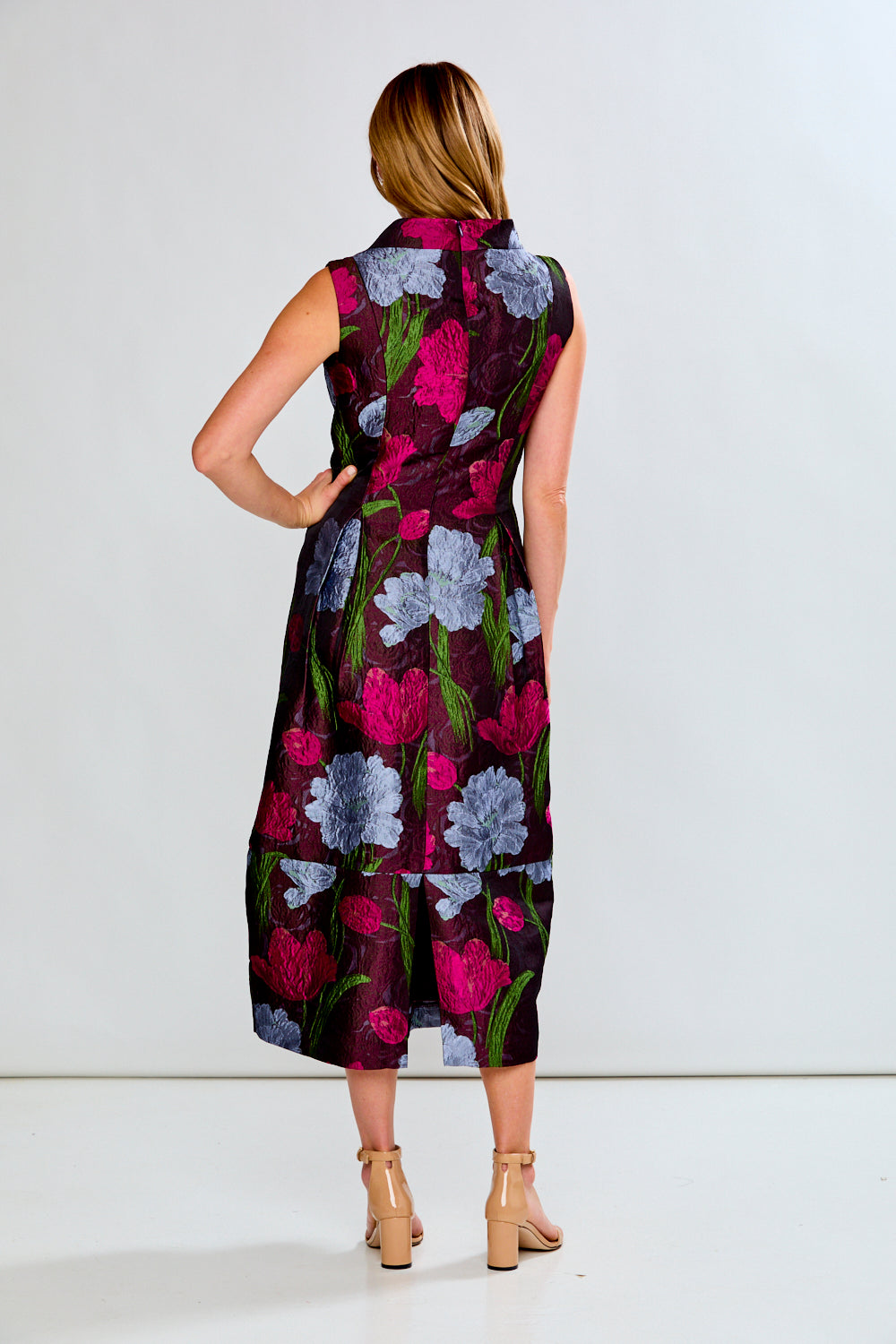 Woman wearing a floral dress on a white background