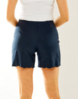 Woman in navy scallop short