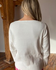 Woman in white scallop hem pullover