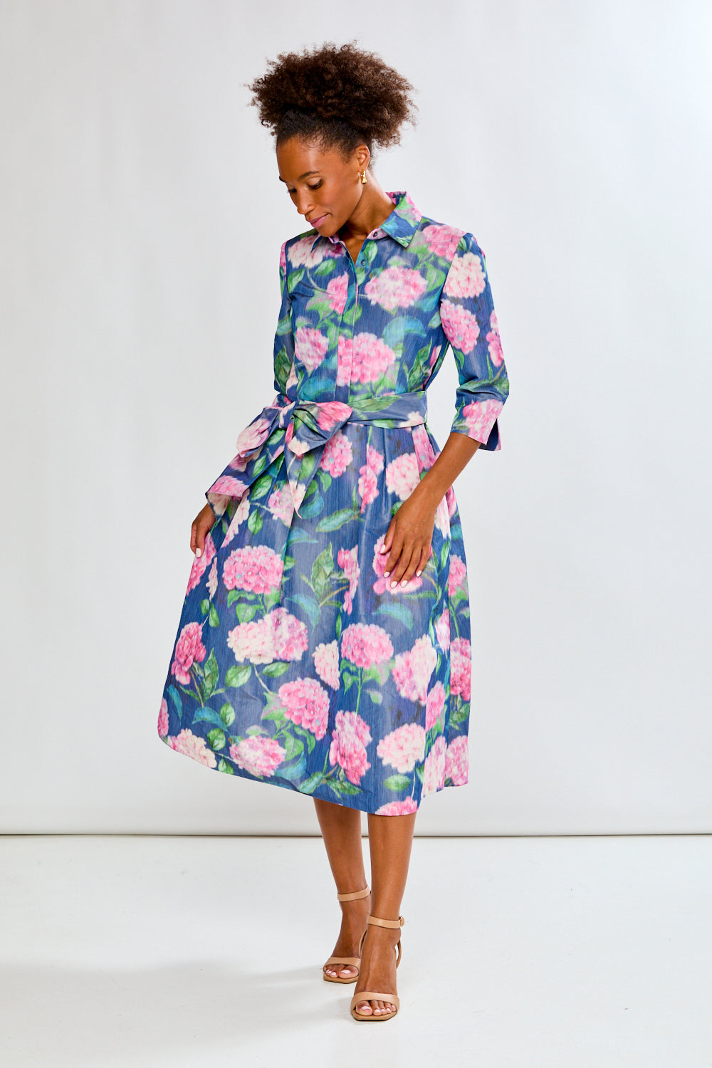 Woman in tea length floral dress