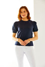 Woman in navy puff sleeve top