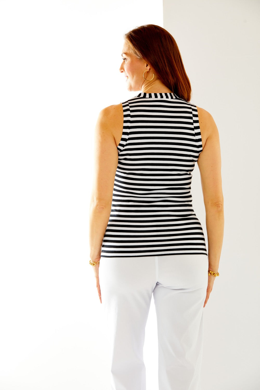 Woman in black/white stripe top