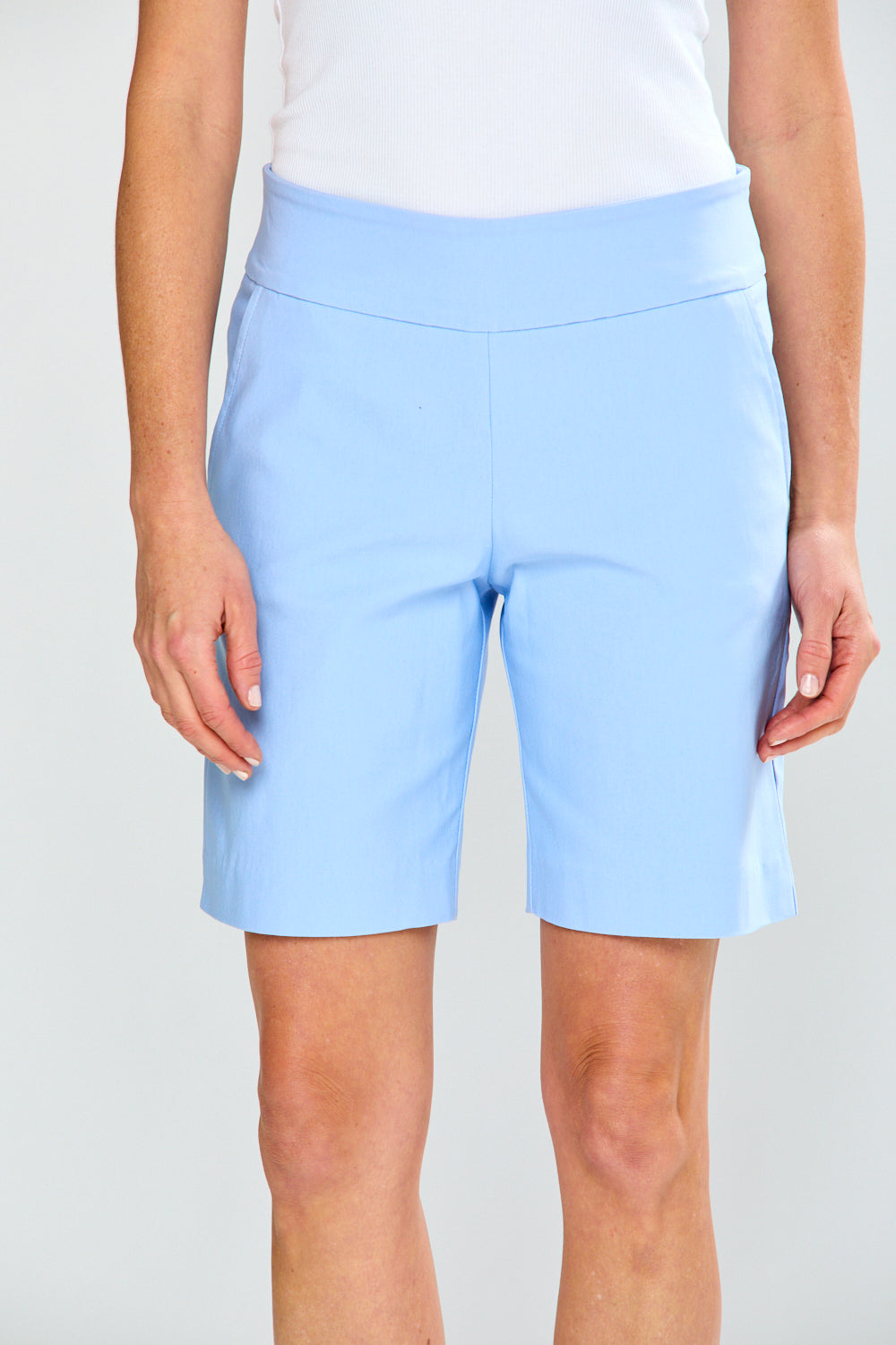 Light blue shorts worn by a person on a white background