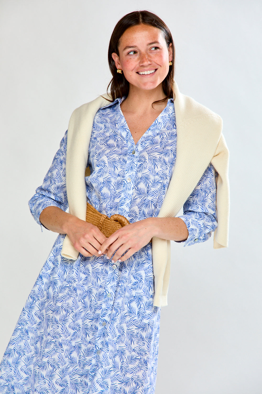 Woman in blue tropical leaf dress